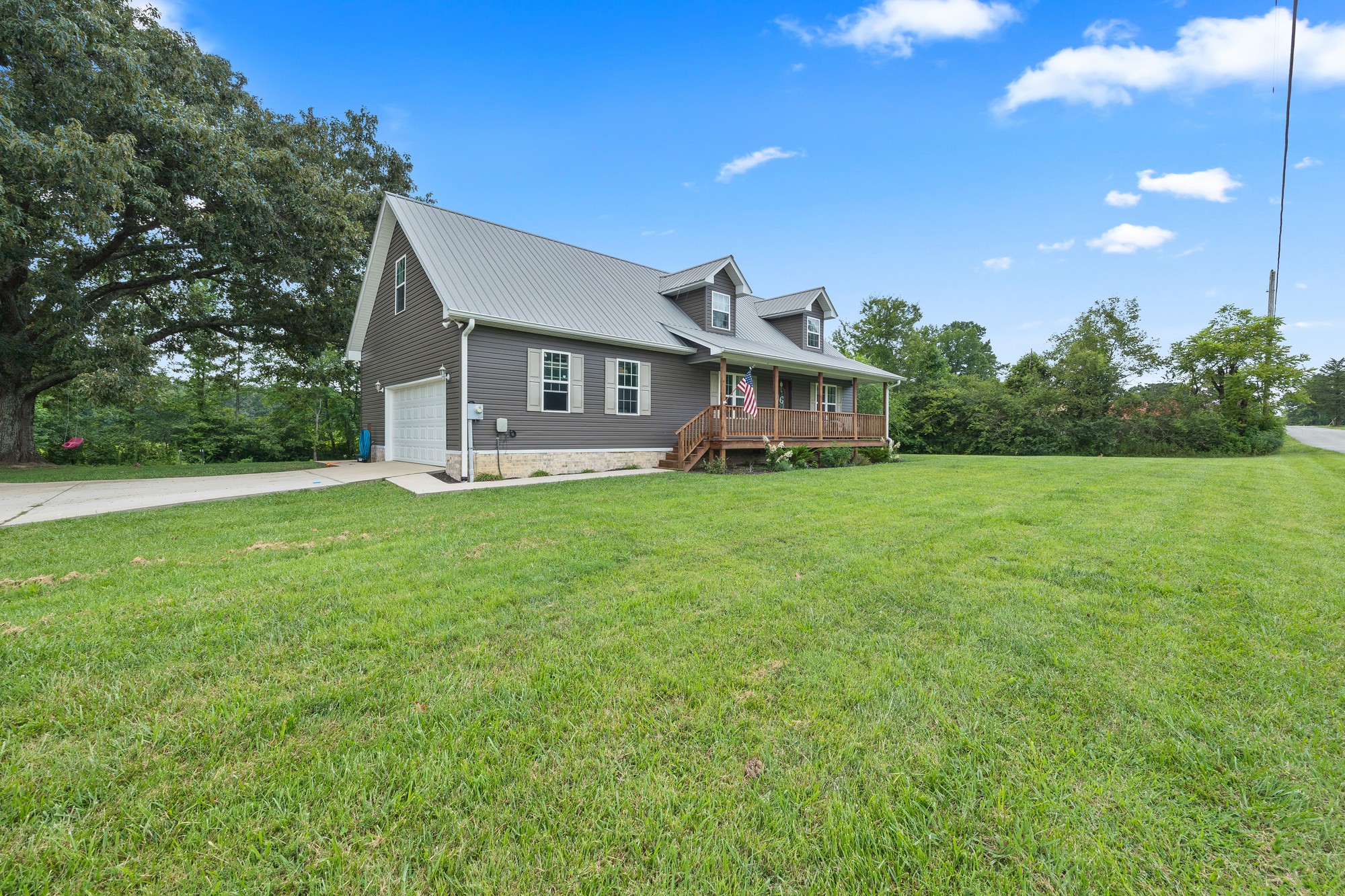 2195 Elmore Town Road Baxter, TN 38544 - Photo 23 of 26 a view of a house with a big yard and potted plants