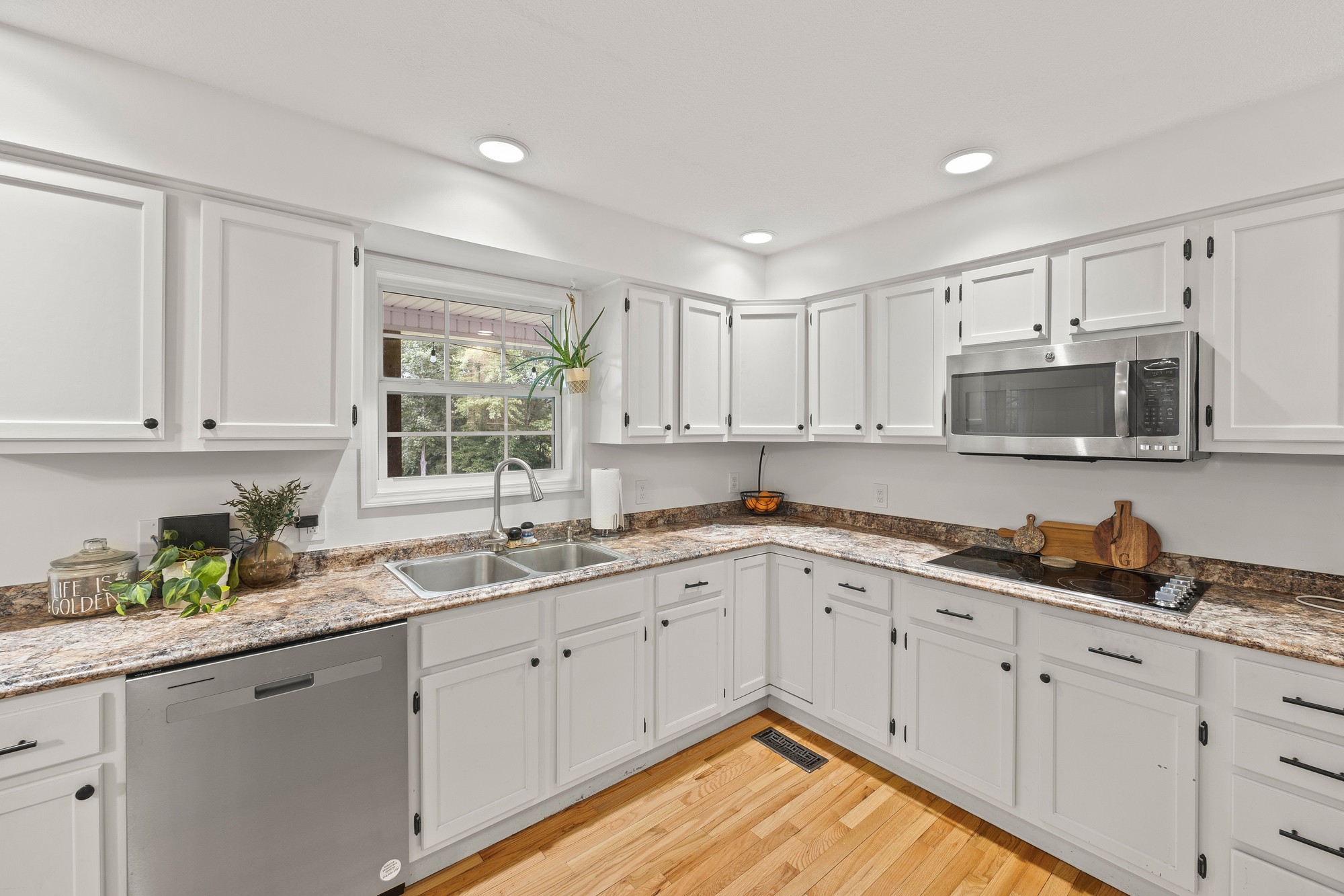 2195 Elmore Town Road Baxter, TN 38544 - Photo 6 of 26 a kitchen with granite countertop white cabinets stainless steel appliances a sink and a window