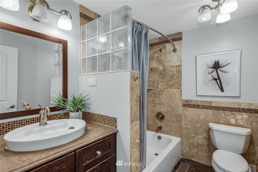 13833 Southeast 142nd Street Renton, WA 98059 - Photo 16 of 22 a bathroom with a bathtub shower sink and toilet