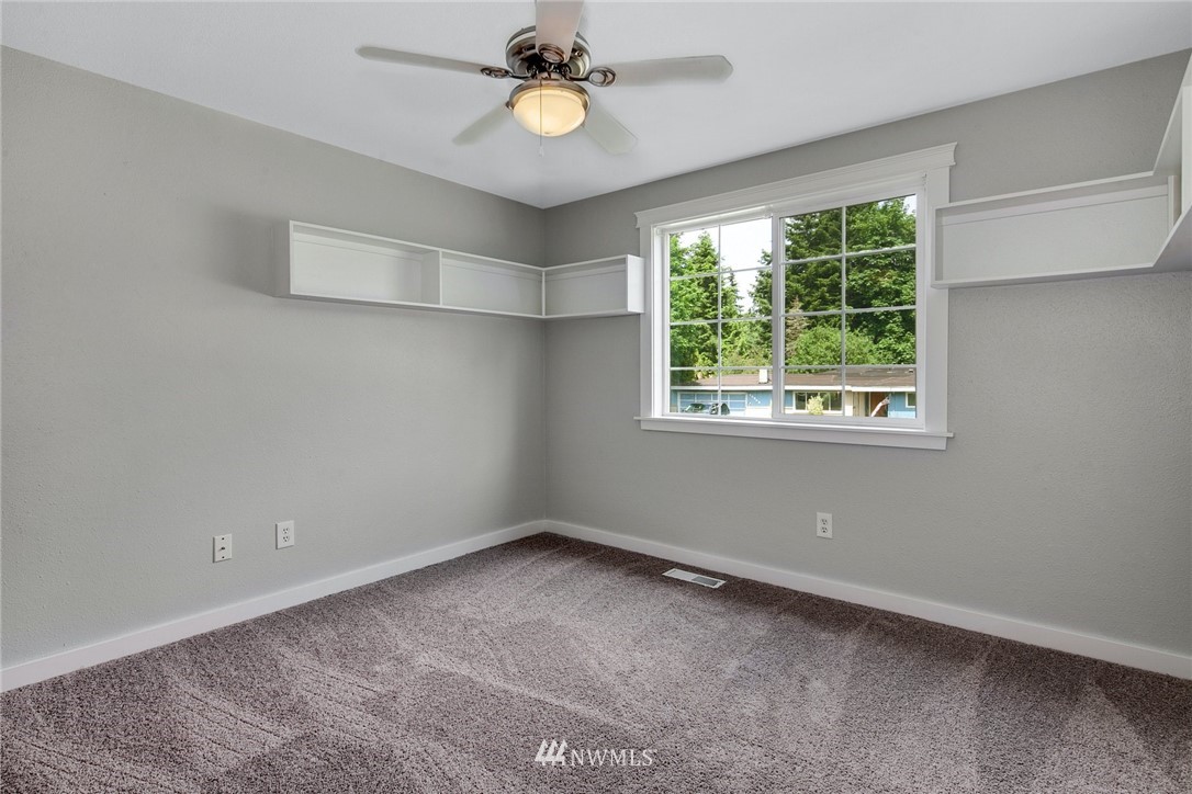 13833 Southeast 142nd Street Renton, WA 98059 - Photo 18 of 22 an empty room with a window and a fan