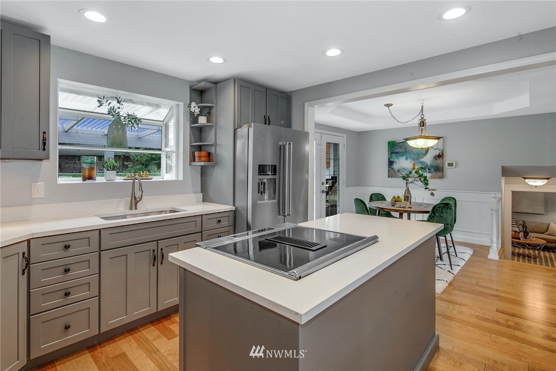 13833 Southeast 142nd Street Renton, WA 98059 - Photo 8 of 22 a kitchen with a sink stove and refrigerator