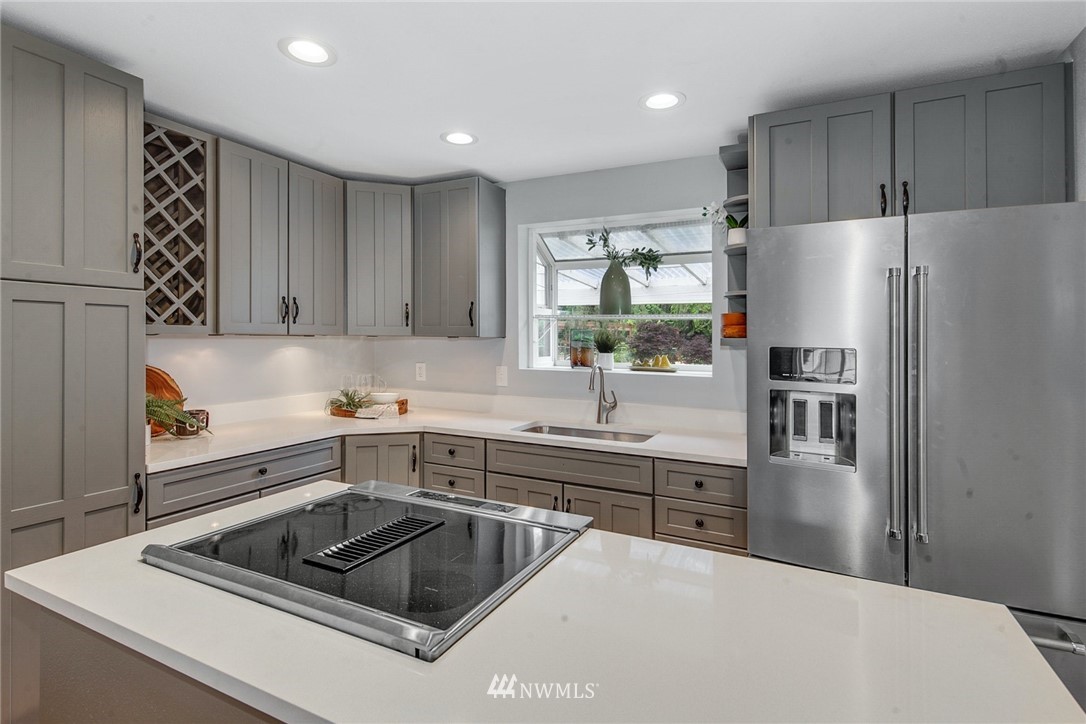 13833 Southeast 142nd Street Renton, WA 98059 - Photo 9 of 22 a kitchen that has a sink cabinets counter space and appliances