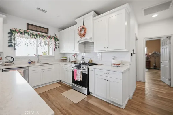 a kitchen with a white cabinets stove and sink