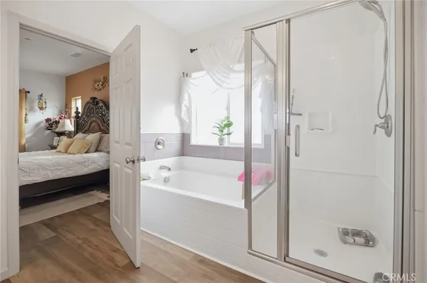 a en suite bathroom with a tub shower and sink