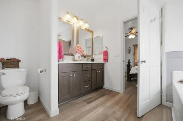 a bathroom with a sink vanity mirror and toilet