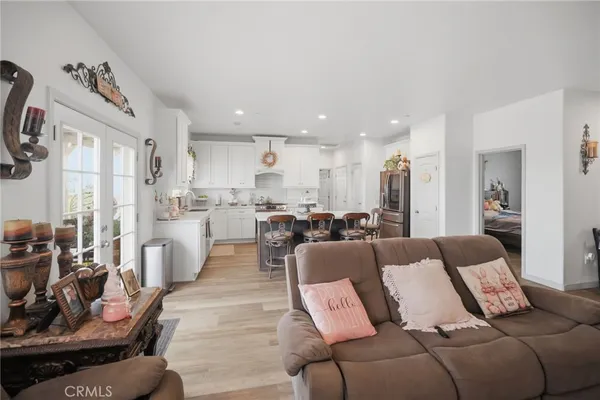 a living room with furniture and a view of kitchen