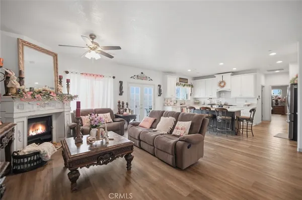 a living room with furniture fireplace and wooden floor