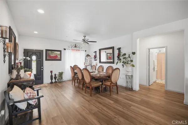 a dining room with furniture a chandelier and wooden floor