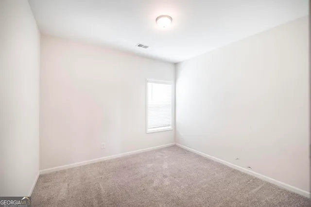 a view of an empty room and a window