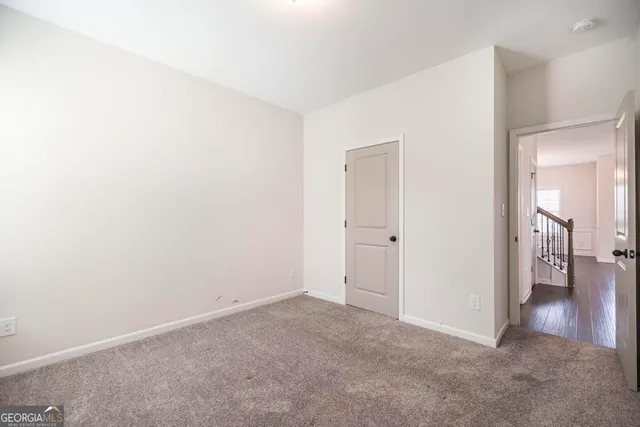 a view of a hallway with a bathroom