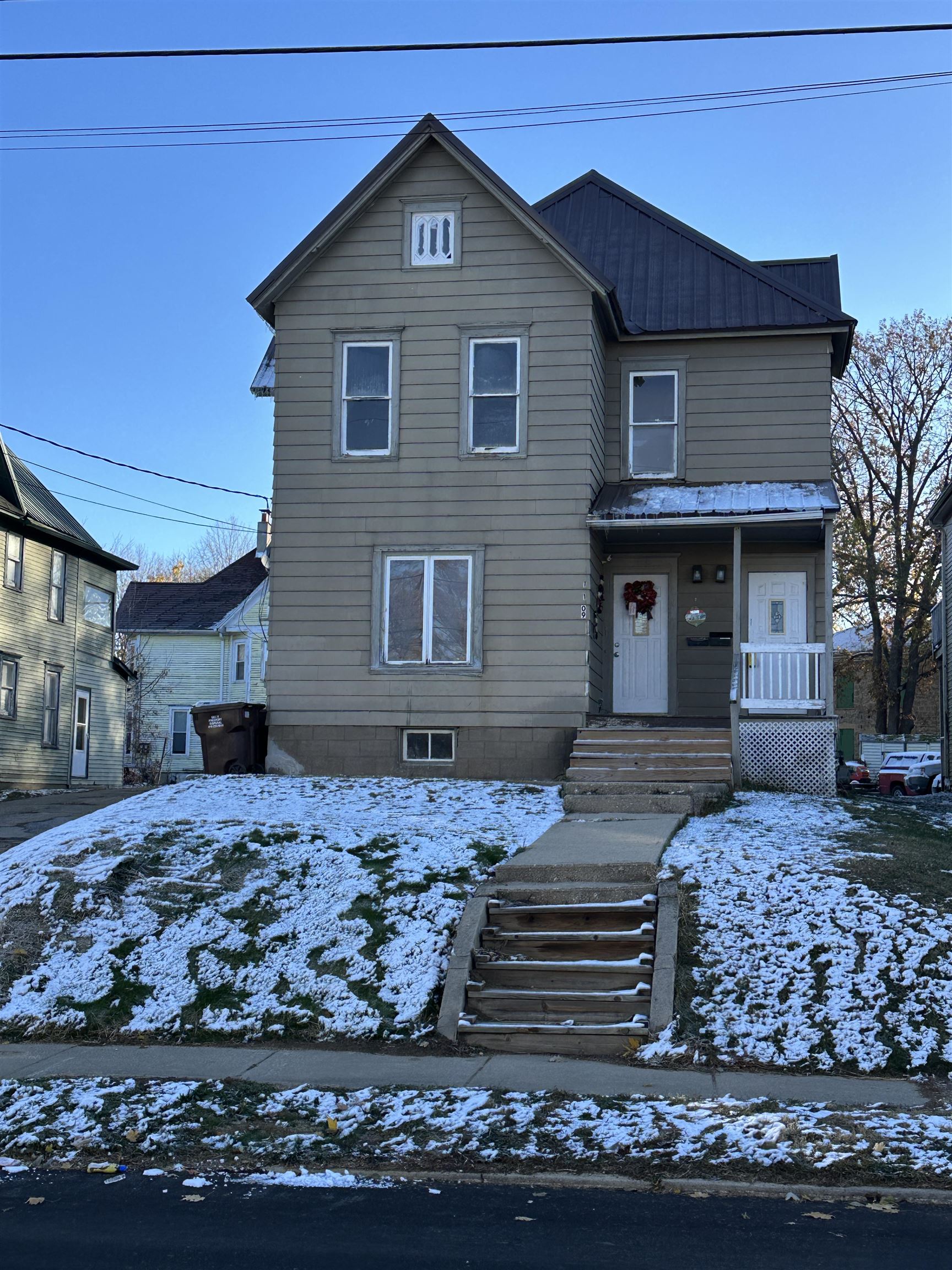 1109 South Carroll Avenue Freeport, IL 61032 - Photo 1 of 34 a front view of a house with a yard