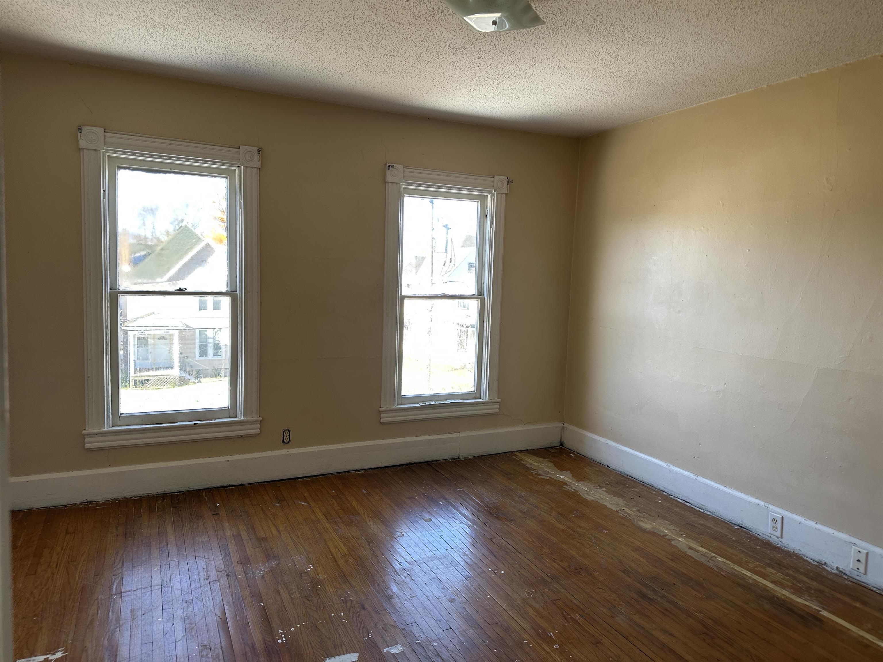 1109 South Carroll Avenue Freeport, IL 61032 - Photo 26 of 34 an empty room with wooden floor and windows