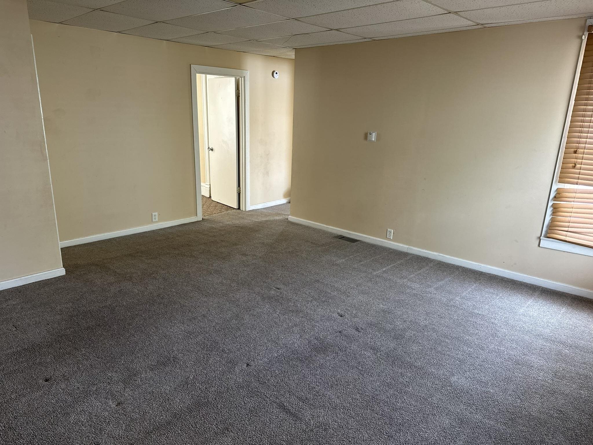 1109 South Carroll Avenue Freeport, IL 61032 - Photo 6 of 34 a view of an empty room and a window