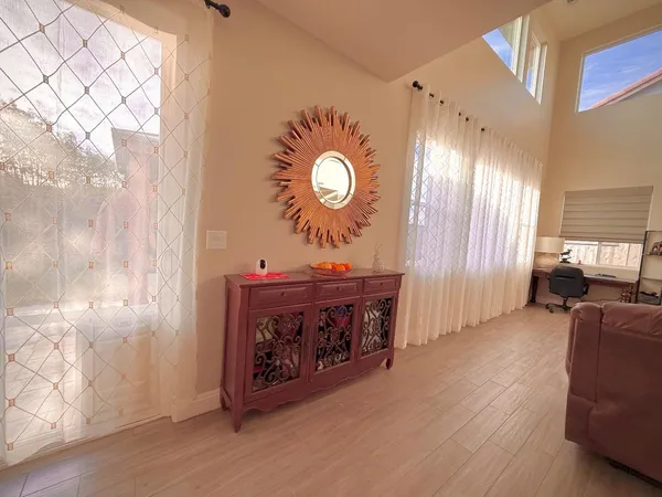 a living room with furniture and a clock