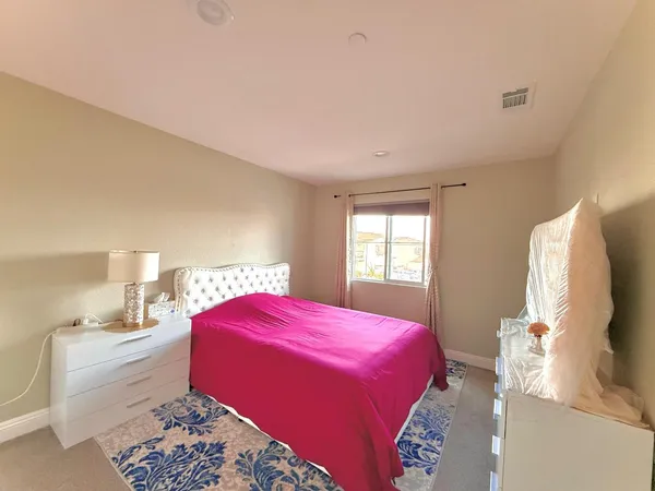 a room with a dresser and wooden floor