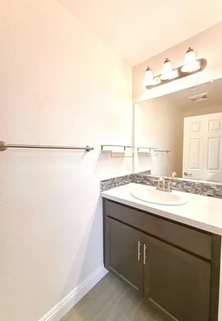 a white toilet sitting next to a bathroom sink