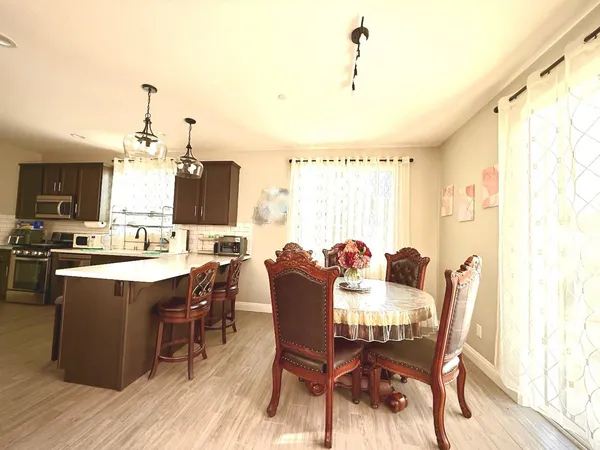a view of a dining room with furniture window and wooden floor