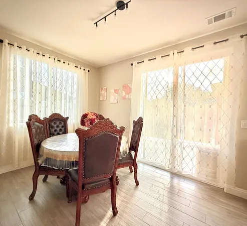 a view of a dining room with furniture and wooden floor