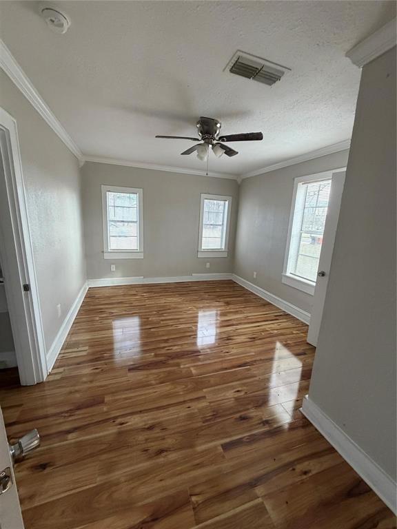 2240 Pin Oak Circle Haughton, LA 71037 - Photo 6 of 9 Unfurnished room with dark wood-style flooring, ceiling fan, ornamental molding, and healthy amount of natural light
