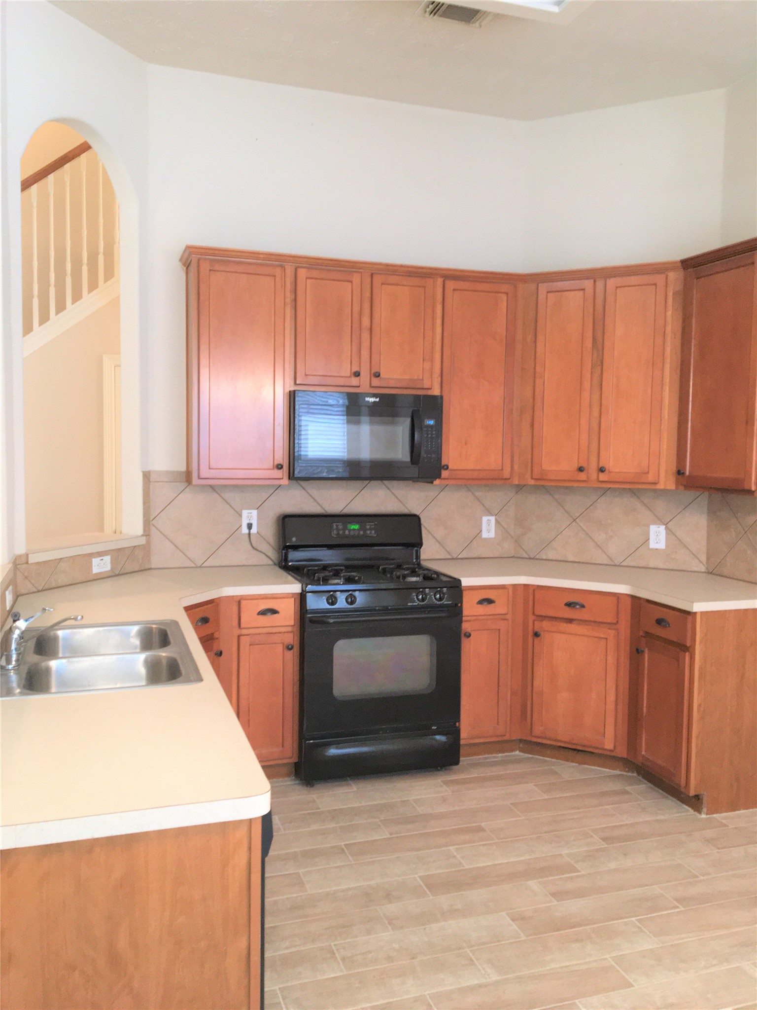 2214 Valley View Crossing Conroe, TX 77304 - Photo 10 of 23 a kitchen with stainless steel appliances granite countertop a sink stove and refrigerator
