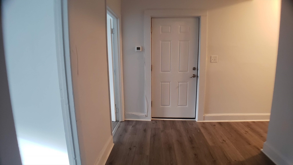 25 Chester Street, Unit 3 Boston, MA 02134 - Photo 5 of 13 a view of an empty room with wooden floor and closet