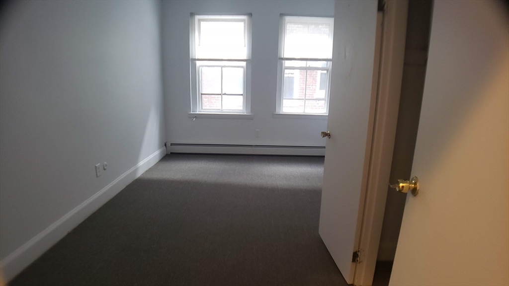 25 Chester Street, Unit 3 Boston, MA 02134 - Photo 10 of 13 an empty room with windows
