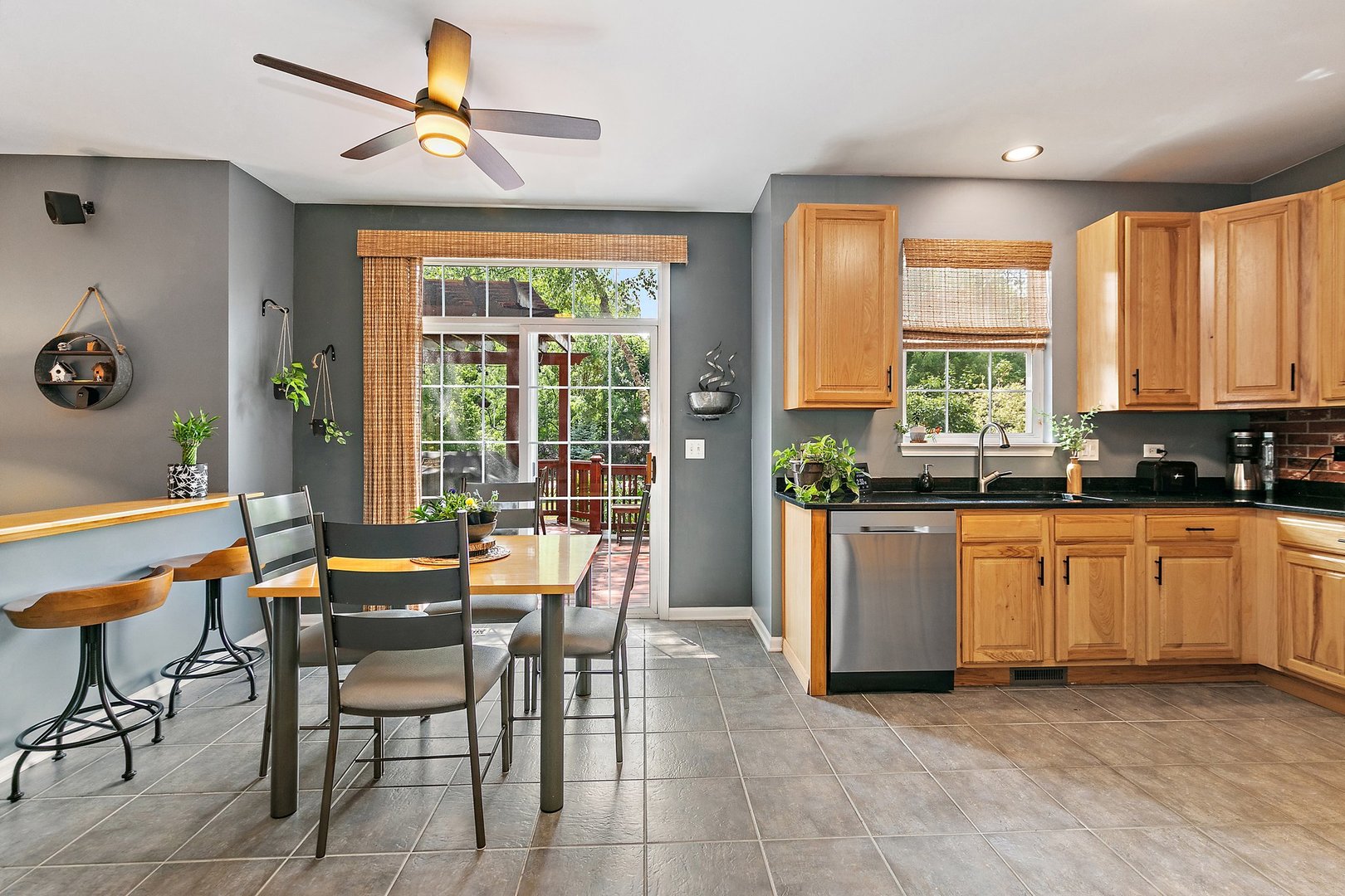 3908 Farmstead Road Carpentersville, IL 60110 - Photo 12 of 47 a kitchen with stainless steel appliances granite countertop dining table chairs and a refrigerator