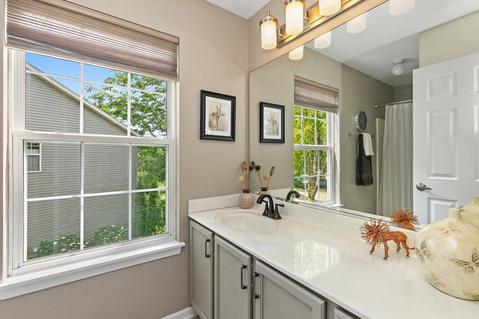 3908 Farmstead Road Carpentersville, IL 60110 - Photo 24 of 47 a bathroom with a double vanity sink and a large mirror