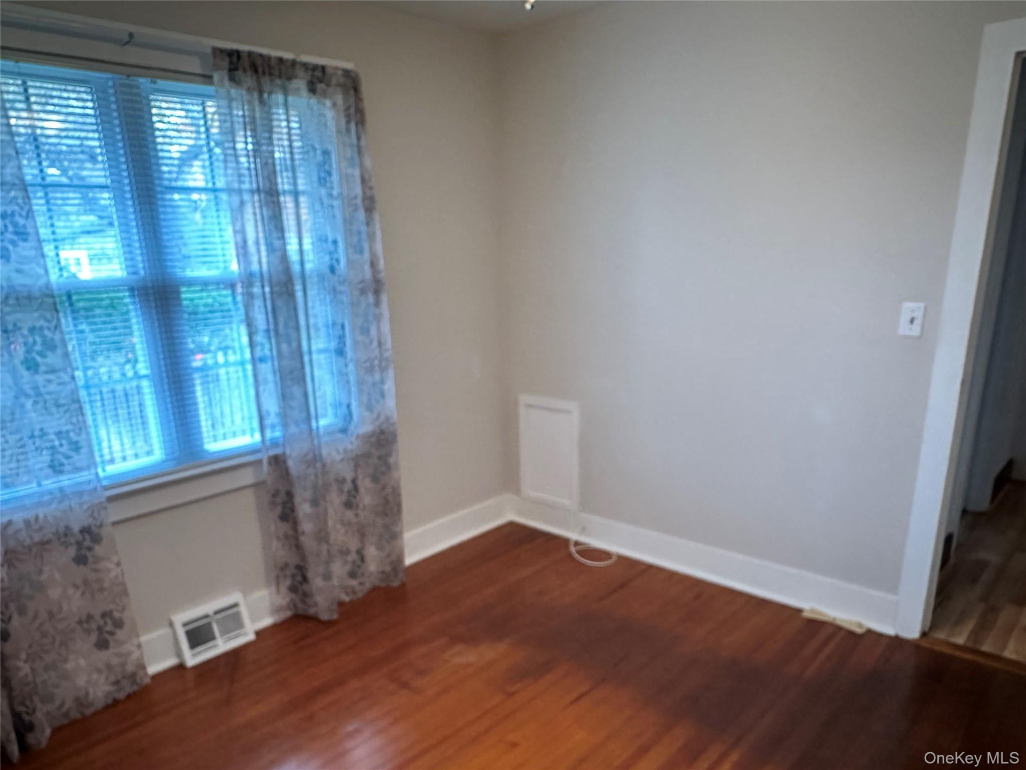 517 Flint Street Greenport, NY 11944 - Photo 11 of 20 1st Bedroom with baseboards and dark wood-type flooring
