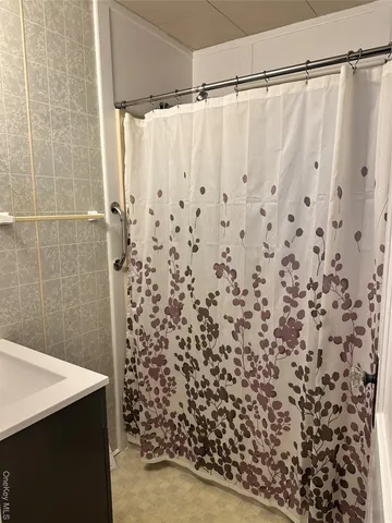 a bathroom with a shower curtain and curtain