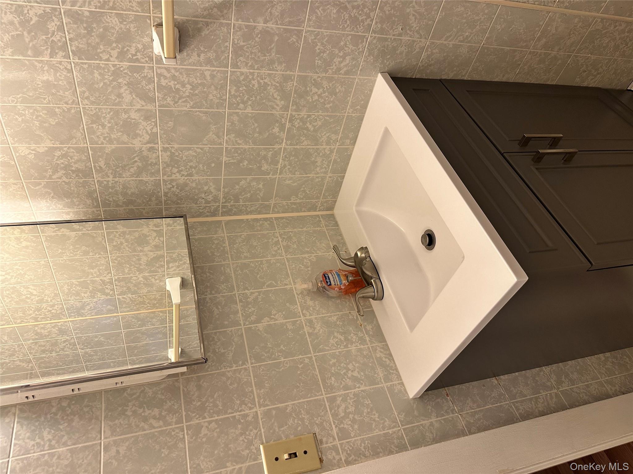 517 Flint Street Greenport, NY 11944 - Photo 14 of 20 Bathroom featuring vanity and tile walls