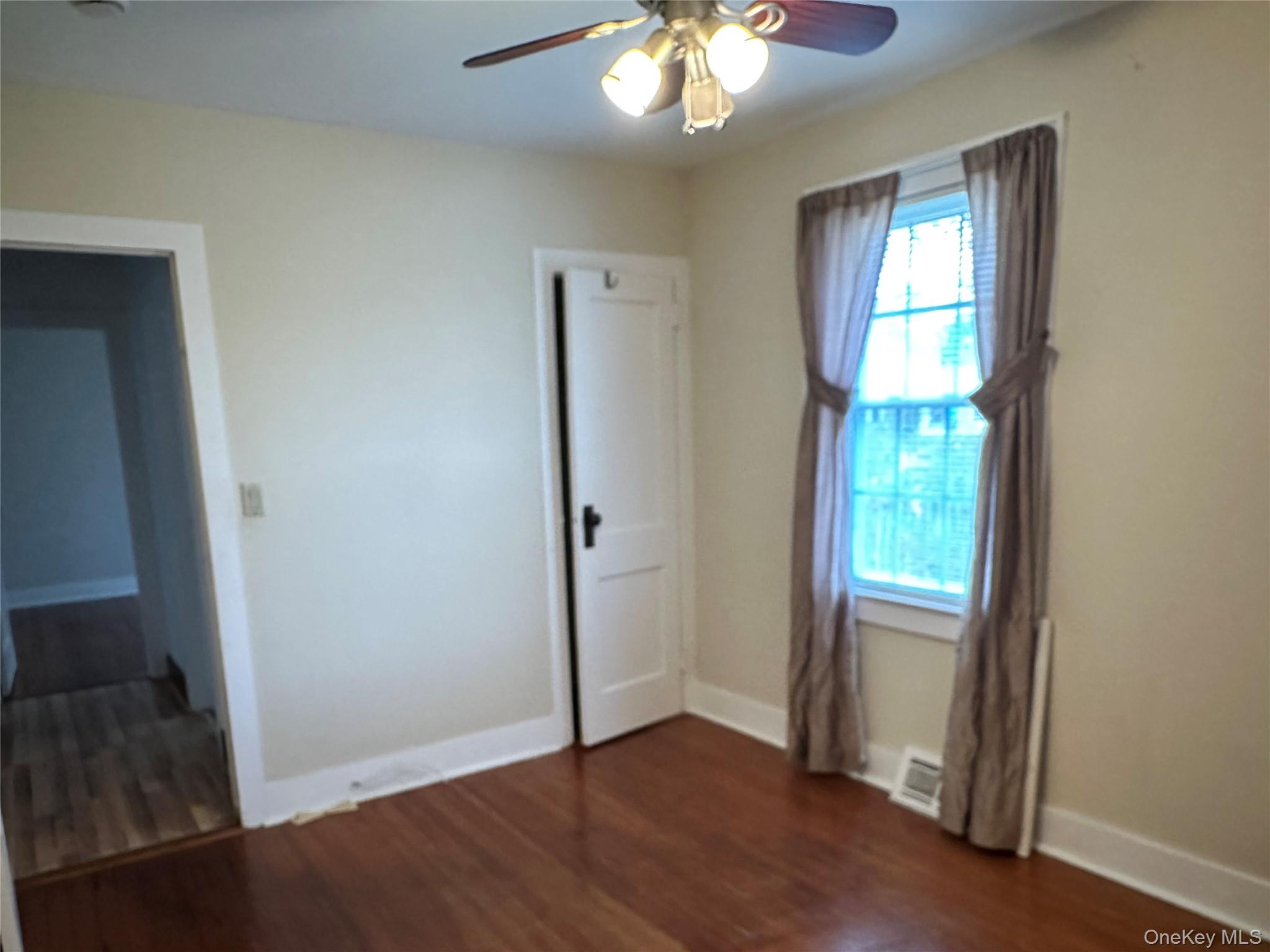 517 Flint Street Greenport, NY 11944 - Photo 16 of 20 2nd Bedroom featuring dark wood-style floors and a ceiling fan