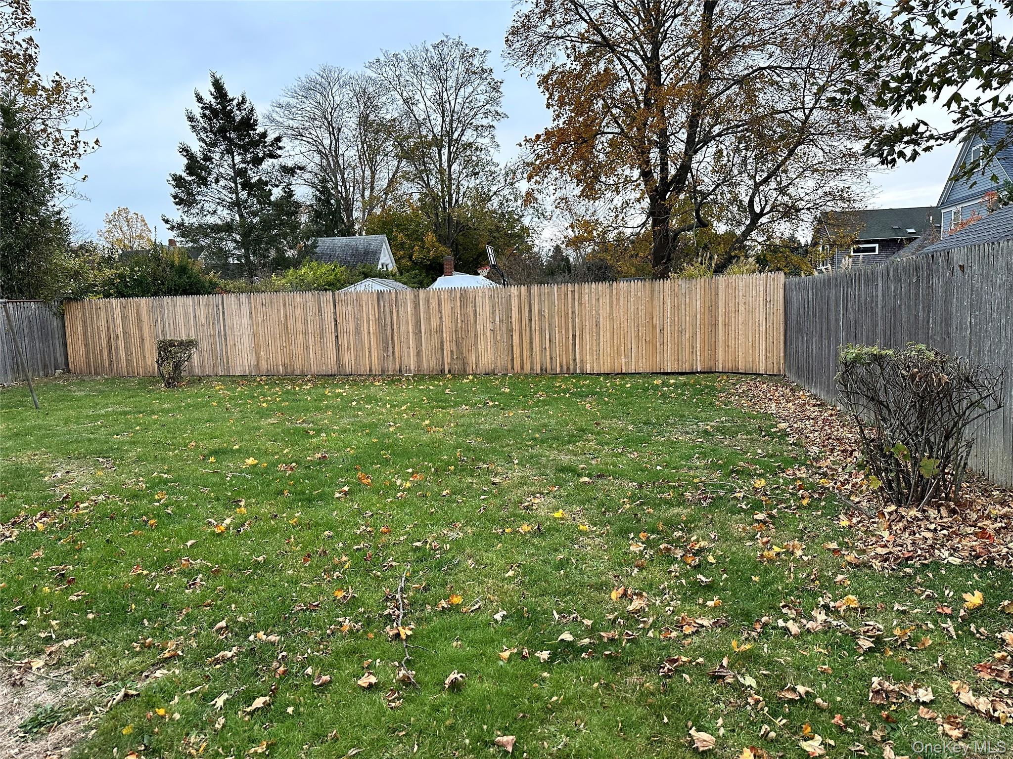 517 Flint Street Greenport, NY 11944 - Photo 20 of 20 View of fully fenced backyard. New fencing recently installed.