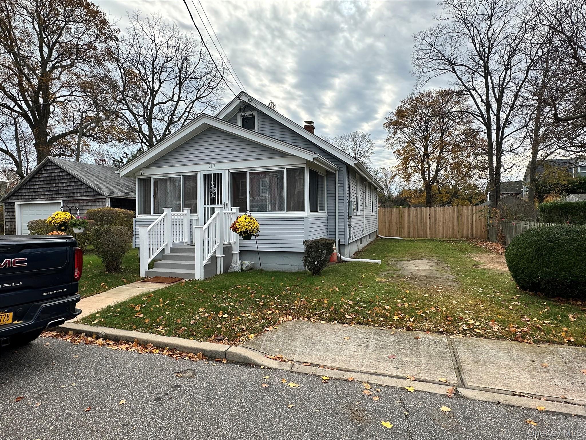 517 Flint Street Greenport, NY 11944 - Photo 3 of 20 Bungalow-style home with a sunroom and a chimney