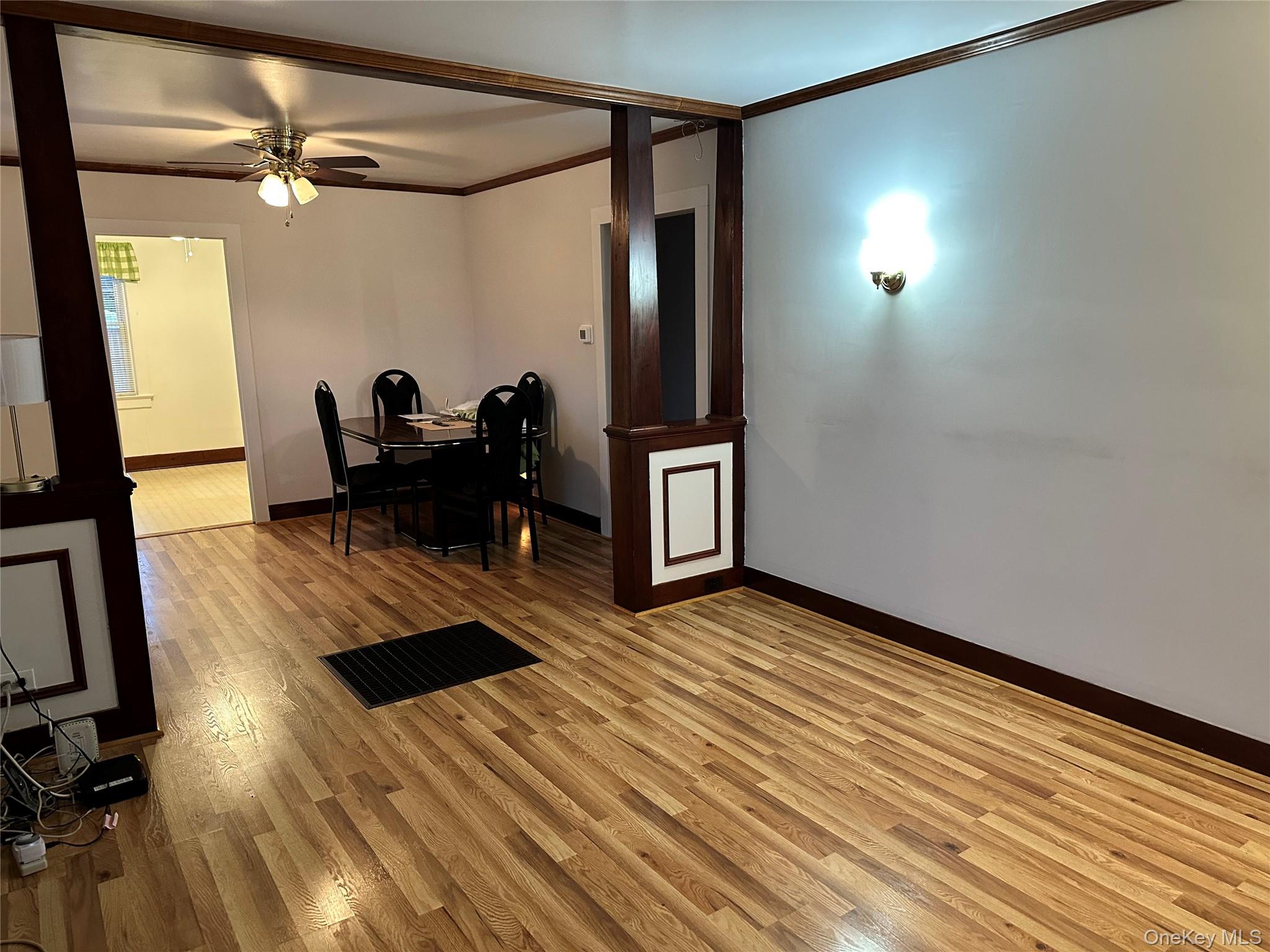 517 Flint Street Greenport, NY 11944 - Photo 6 of 20 Living room featuring ornamental molding, and light wood-style flooring.
