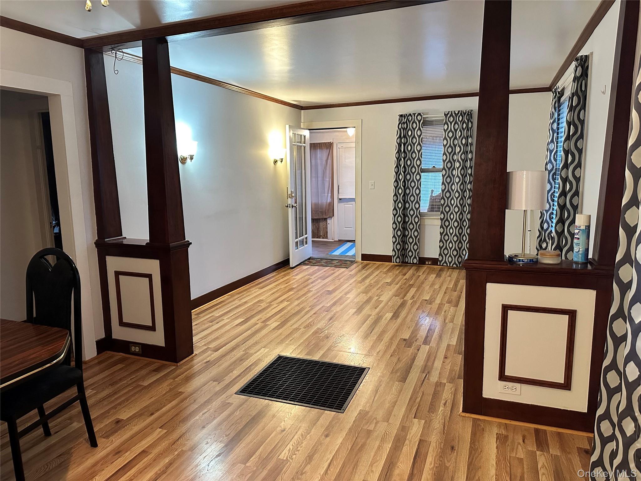 517 Flint Street Greenport, NY 11944 - Photo 7 of 20 Dining Room featuring ornamental molding, light wood-style flooring and a ceiling fan.