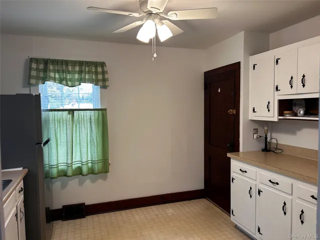 a kitchen with stainless steel appliances granite countertop a refrigerator a sink a stove and a refrigerator