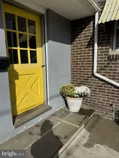 a view of a brick house with potted plants