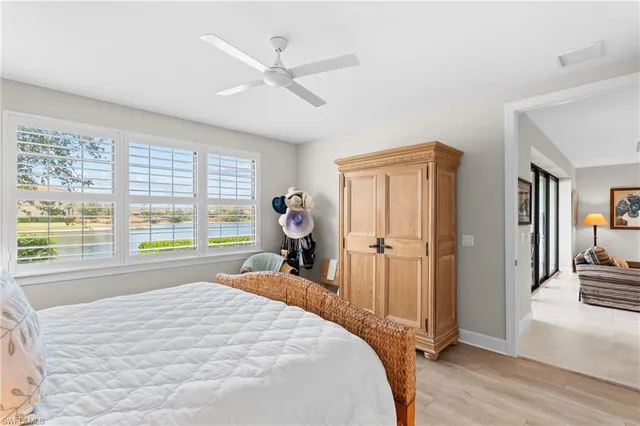 a bed room with a bed and a large window