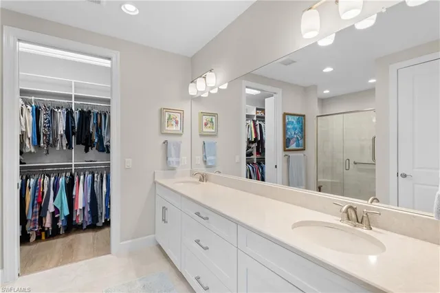 a spacious bathroom with a double vanity sink double and a mirror