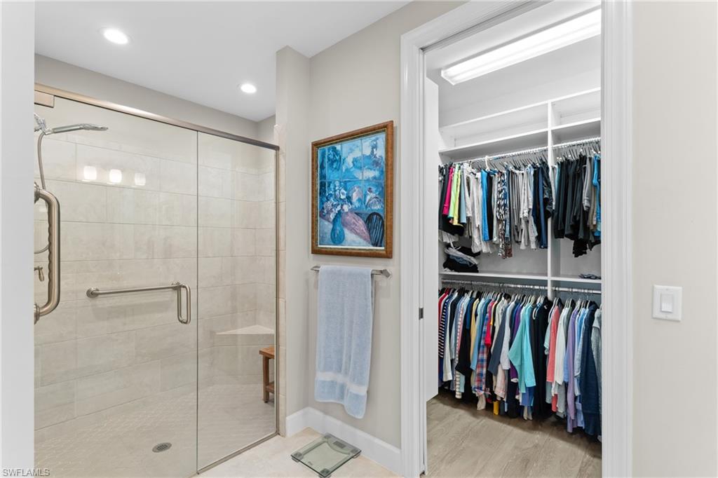 9646 Montelanico Loop, Unit 102 Naples, FL 34119 - Photo 15 of 42 a view of walk in closet with clothes and shoes