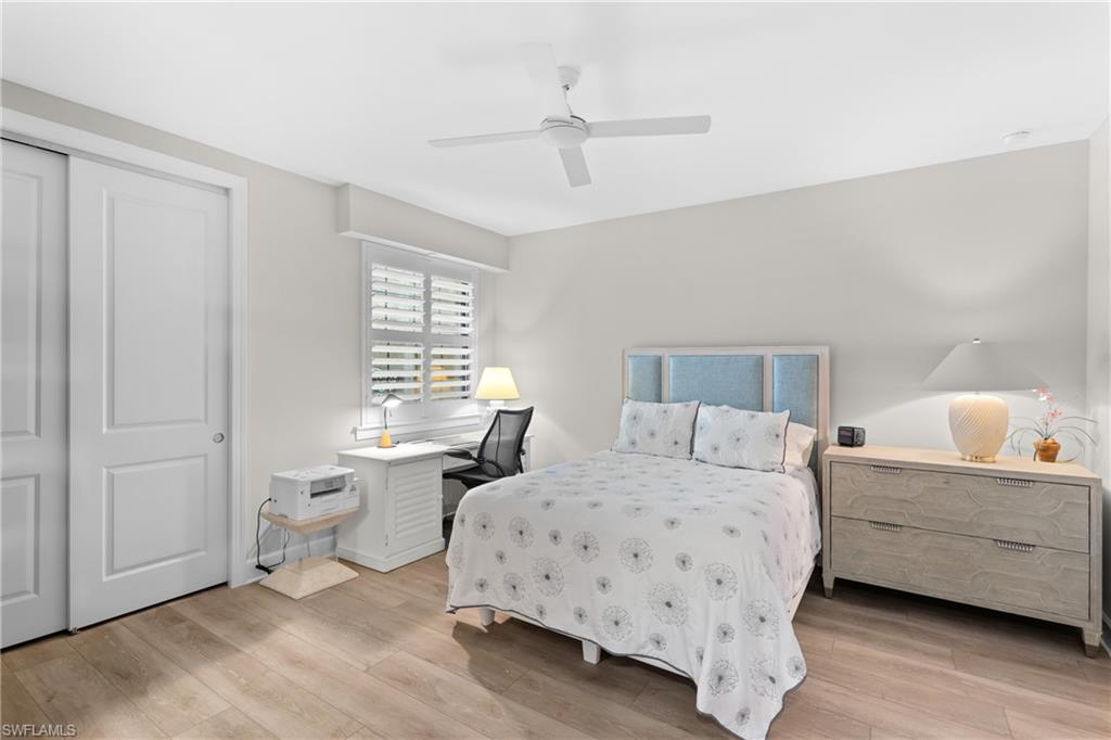 9646 Montelanico Loop, Unit 102 Naples, FL 34119 - Photo 17 of 42 a bedroom with a bed and a window