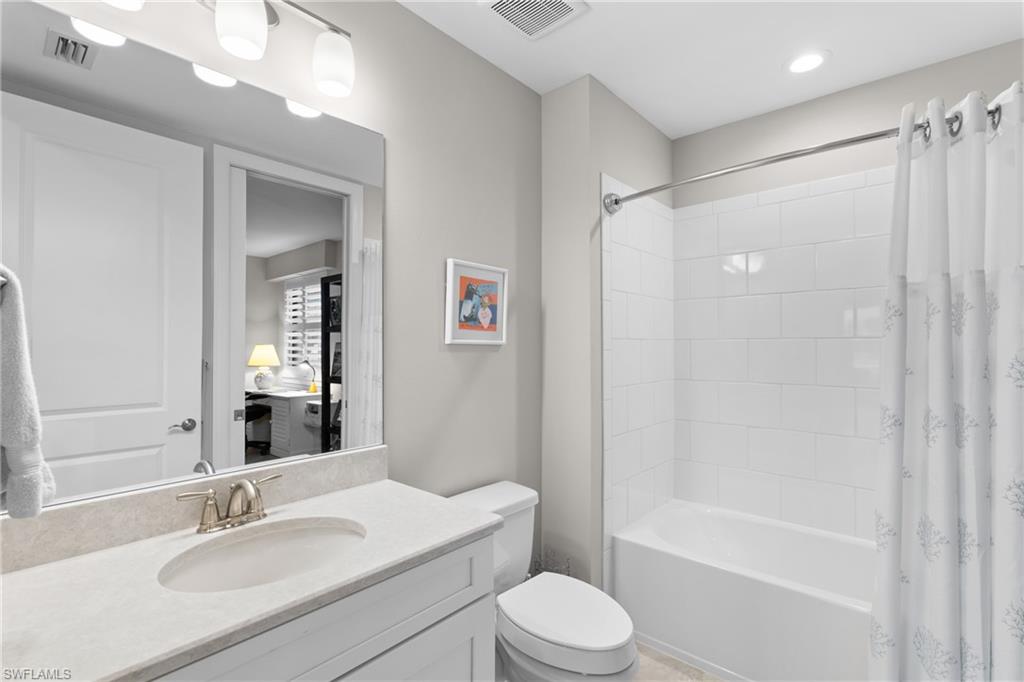 9646 Montelanico Loop, Unit 102 Naples, FL 34119 - Photo 18 of 42 a bathroom with a sink a toilet and shower