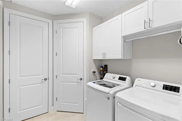 a view of storage and utility room with washer and dryer