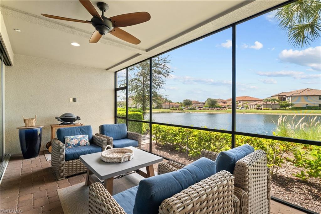 9646 Montelanico Loop, Unit 102 Naples, FL 34119 - Photo 20 of 42 a living room with furniture and a floor to ceiling window