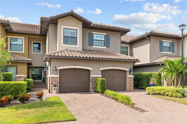 a front view of a house with a yard and garage