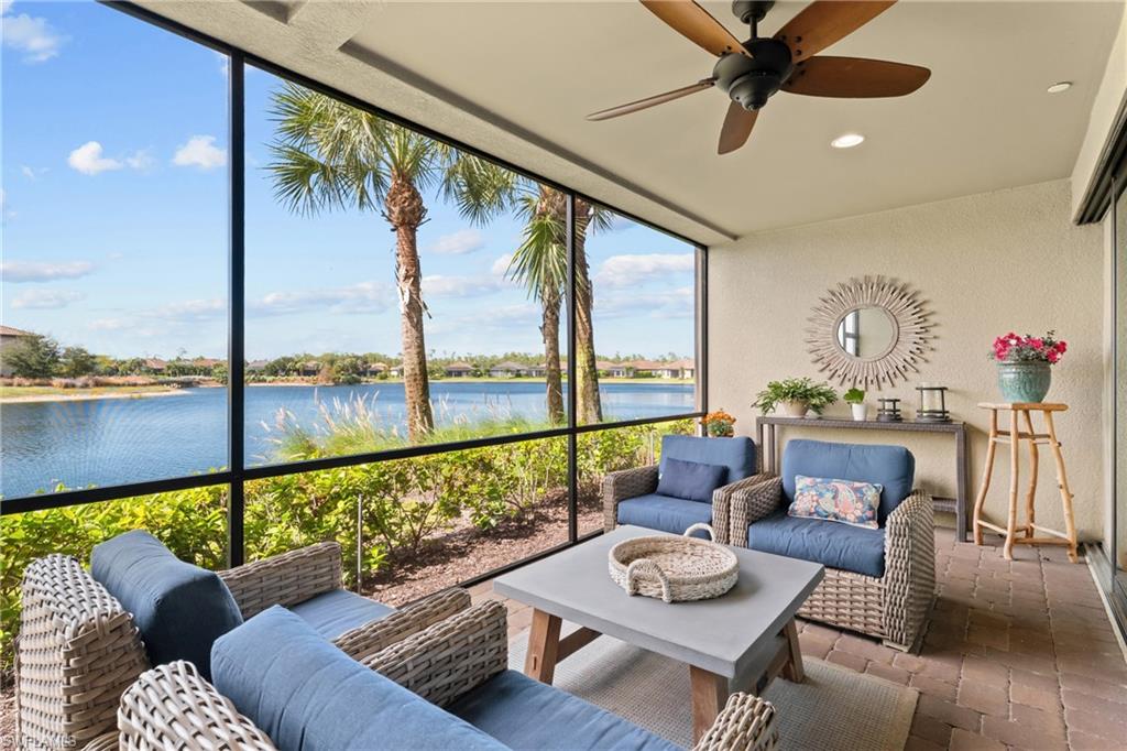 9646 Montelanico Loop, Unit 102 Naples, FL 34119 - Photo 22 of 42 a living room with furniture and a large window