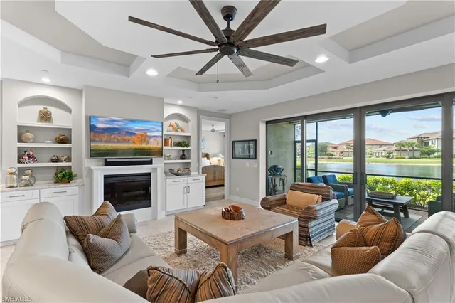 a living room with furniture fireplace and a large window