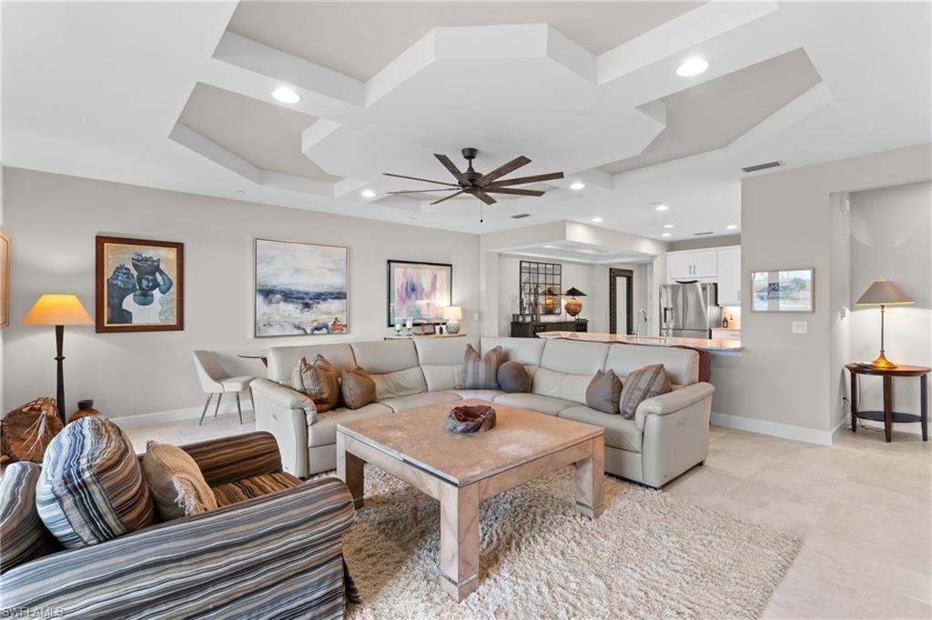 9646 Montelanico Loop, Unit 102 Naples, FL 34119 - Photo 5 of 42 a living room with furniture ceiling fan and a rug