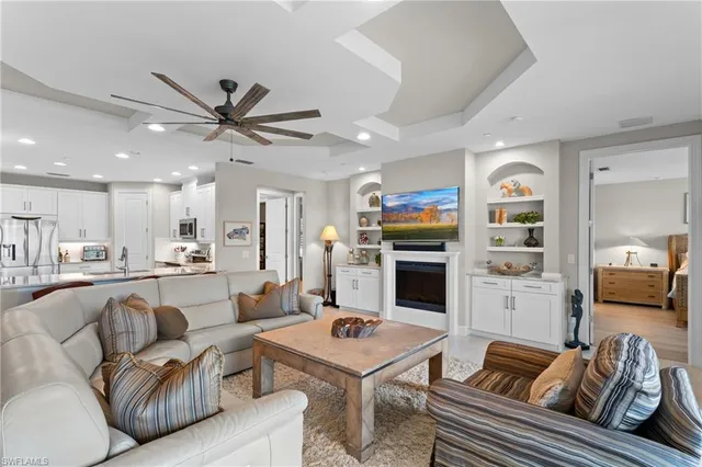 a living room with furniture kitchen view and a fireplace